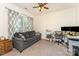 Comfortable office with large window, sofa, desk, and ceiling fan at 4861 Samuel Pinckney Dr, Belmont, NC 28012