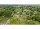 An aerial view shows the home on a spacious lot in a neighborhood of tree-lined streets at 4935 Kennedy St, Hickory, NC 28602