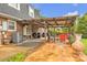 Covered patio with a grill, outdoor seating, and a large backyard, ideal for summer barbecues at 4935 Kennedy St, Hickory, NC 28602