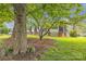 Charming two-story home with brick accents, nestled on a spacious lot with mature trees and lush greenery at 4935 Kennedy St, Hickory, NC 28602