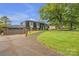 Charming two-story home with brick facade, manicured lawn, and mature trees creates a welcoming curb appeal at 4935 Kennedy St, Hickory, NC 28602