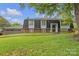 Charming two-story home with brick facade, manicured lawn, and mature trees creates a welcoming curb appeal at 4935 Kennedy St, Hickory, NC 28602