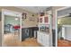Pass through to the kitchen area with cabinetry, microwave, and view to the dining area at 4935 Kennedy St, Hickory, NC 28602