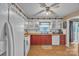 Functional kitchen featuring ample cabinet space, a mix of white and red cabinets, and laminate wood flooring at 4935 Kennedy St, Hickory, NC 28602