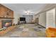 Inviting living room features a brick fireplace, colorful carpet tiles and neutral walls at 4935 Kennedy St, Hickory, NC 28602