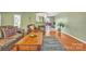 Inviting living room featuring hardwood floors, a cozy seating arrangement, and natural light from a window at 4935 Kennedy St, Hickory, NC 28602