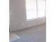 Bright living room with large windows and neutral carpeting, creating a cozy atmosphere at 5180 Macedonia Church Rd, Vale, NC 28168