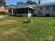 Backyard with a brick fire pit, and a covered porch attached to a white brick house at 629 Belmorrow Dr, Charlotte, NC 28214