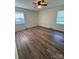 This is a bedroom featuring hardwood floors and two windows at 629 Belmorrow Dr, Charlotte, NC 28214