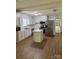 Updated kitchen featuring white cabinets, stainless steel appliances, and a kitchen island at 629 Belmorrow Dr, Charlotte, NC 28214