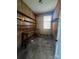 Small storage room with wooden shelves, wood paneled walls and a small window at 629 Belmorrow Dr, Charlotte, NC 28214