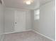 Cozy bedroom featuring neutral walls, plush carpeting, and a window with blinds at 668 Riverside Dr, Lincolnton, NC 28092