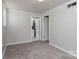 Carpeted bedroom with doors to the bathroom and closet space at 668 Riverside Dr, Lincolnton, NC 28092