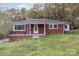 Charming brick ranch home featuring a cozy front porch and well-maintained lawn at 668 Riverside Dr, Lincolnton, NC 28092