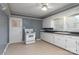 Kitchen featuring white cabinetry, a white electric range, and a double-basin sink at 668 Riverside Dr, Lincolnton, NC 28092
