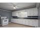 Kitchen featuring white cabinetry, a white electric range, and a double-basin sink at 668 Riverside Dr, Lincolnton, NC 28092