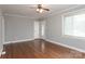 Living room with hardwood floors, a ceiling fan, and a large window at 668 Riverside Dr, Lincolnton, NC 28092
