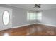 Living room with hardwood floors, a ceiling fan, and a large window at 668 Riverside Dr, Lincolnton, NC 28092