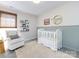 Bright Bedroom featuring a rocking chair, a white crib, and decor at 7731 Ivy Hollow Dr, Charlotte, NC 28227