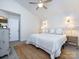 Bright bedroom featuring a ceiling fan, a comfortable bed and stylish sconces at 7731 Ivy Hollow Dr, Charlotte, NC 28227