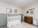 Cozy Bedroom featuring a crib, a dresser with a changing table, and wall decor at 7731 Ivy Hollow Dr, Charlotte, NC 28227