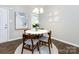 Cozy dining area featuring a round table, wood chairs, and a stylish chandelier at 7731 Ivy Hollow Dr, Charlotte, NC 28227