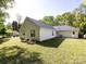 Back of house with tidy landscaping, offering a glimpse of outdoor living and curb appeal at 7731 Ivy Hollow Dr, Charlotte, NC 28227