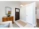 Inviting foyer with wood floors, a stylish mirror, a wooden cabinet, and a charming front door at 7731 Ivy Hollow Dr, Charlotte, NC 28227