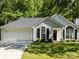 Charming single-story home with a well-maintained lawn, attached garage, and inviting curb appeal at 7731 Ivy Hollow Dr, Charlotte, NC 28227