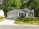 Single-story home with attached garage and landscaped front yard, showcasing its pleasant curb appeal at 7731 Ivy Hollow Dr, Charlotte, NC 28227