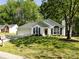 Inviting single-story home with green lawn, mature trees, attached garage, and charming front exterior at 7731 Ivy Hollow Dr, Charlotte, NC 28227