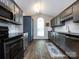 Updated kitchen boasts stainless appliances, ample counter space, and modern cabinetry at 7731 Ivy Hollow Dr, Charlotte, NC 28227