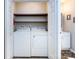 A laundry room featuring a washer and dryer with wood shelving above at 7731 Ivy Hollow Dr, Charlotte, NC 28227