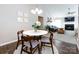 Open-concept living room with fireplace, comfortable seating, and bright natural light at 7731 Ivy Hollow Dr, Charlotte, NC 28227