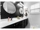 Well decorated bathroom with dual sinks, dark cabinets, gold hardware, and a shower at 7850 Bud Henderson Rd, Huntersville, NC 28078
