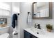 Cozy bathroom featuring a blue vanity, toilet, wall mirror, towel bar and green plant at 7850 Bud Henderson Rd, Huntersville, NC 28078