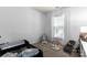 Neutral baby's room, complete with bassinet, soft rug, play gym, and window at 7850 Bud Henderson Rd, Huntersville, NC 28078
