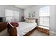 Inviting bedroom features neutral walls, plush carpeting, and lots of natural light from the large window at 7850 Bud Henderson Rd, Huntersville, NC 28078