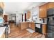 Bright kitchen boasts wood cabinets, modern appliances, and an open layout to the dining and living areas at 7850 Bud Henderson Rd, Huntersville, NC 28078