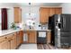 Well-lit kitchen featuring oak cabinets, ample counter space, and modern stainless steel appliances at 7850 Bud Henderson Rd, Huntersville, NC 28078