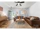 Inviting living room featuring a piano, comfortable seating, and an open layout leading to the outdoors at 7850 Bud Henderson Rd, Huntersville, NC 28078