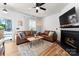 Bright living room featuring a fireplace, comfortable seating, modern lighting, and an inviting atmosphere at 7850 Bud Henderson Rd, Huntersville, NC 28078