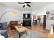 Bright living room with modern light fixture, fireplace, comfortable seating, and open-concept design at 7850 Bud Henderson Rd, Huntersville, NC 28078