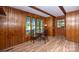 This dining area features wood paneling, hardwood floors, and an exterior door at 7851 Green Cove Ct, Denver, NC 28037