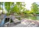 Wooden dock on the water offers a serene spot with lush greenery, inviting you to enjoy peaceful lakeside living at 7851 Green Cove Ct, Denver, NC 28037