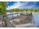 Lakefront dock with wooden planks providing direct access to the water, showcasing waterfront living and recreational opportunities at 7851 Green Cove Ct, Denver, NC 28037