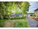 Charming brick home nestled among mature trees with a cozy front yard at 7851 Green Cove Ct, Denver, NC 28037