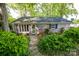 Charming brick home with mature landscaping, a stone walkway, and a cozy, inviting entrance at 7851 Green Cove Ct, Denver, NC 28037