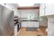Bright kitchen with white cabinets, updated appliances, hardwood floors, and plenty of natural light at 7851 Green Cove Ct, Denver, NC 28037
