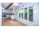 Bright living area with hardwood floors, a ceiling fan, and a view of the lush outdoor landscape at 7851 Green Cove Ct, Denver, NC 28037